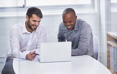 Buy stock photo Two businessmen sitting in an office with a laptop while having a meeting