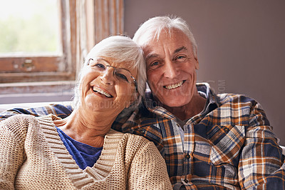 Buy stock photo Senior couple, smile and portrait in sofa with hug, love and connection in living room for retirement. Elderly woman, old man and embrace on lounge lounge with pride, care and happy in apartment