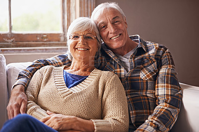 Buy stock photo Senior couple, happy and portrait in sofa with hug, love and connection in living room for retirement. Elderly woman, old man and embrace on lounge couch with pride, care and smile in apartment