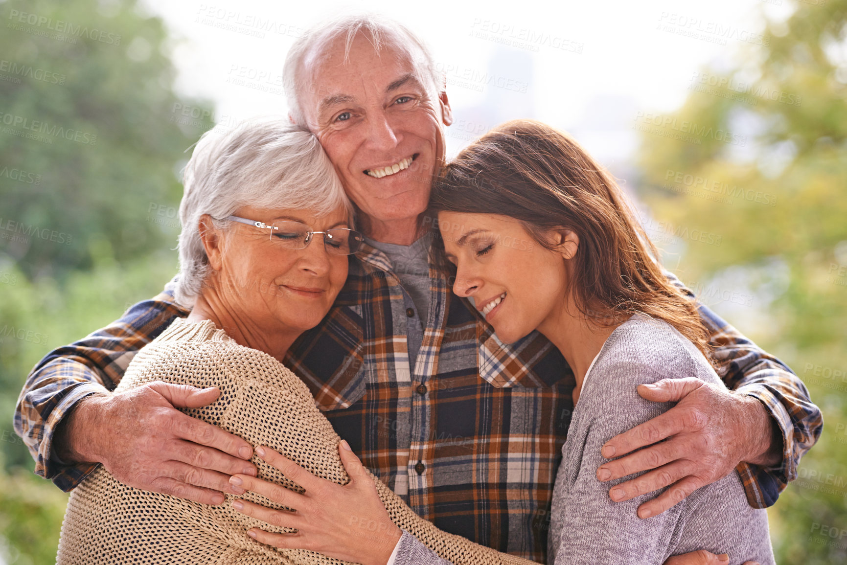 Buy stock photo Outdoor, portrait and happy old man with family in nature, relax and smile from wife and daughter. Park, adult and male person embrace women with love for visit of girl, parents and retirement