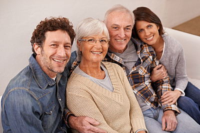 Buy stock photo A portrait of happy mature parents sitting with their adult children at home