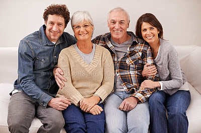Buy stock photo Couple, elderly parents and portrait on sofa with smile, hug and care with bonding, relax and pride in home. Father, mother and happy with women, men and embrace with love on couch in family house