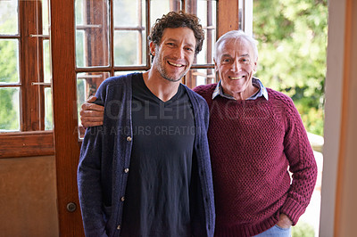 Buy stock photo Son, senior father and portrait in home by front door with hug, smile and bonding with connection. Men, elderly dad and adult child with embrace for love, visit and holiday with pride in family house
