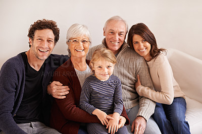 Buy stock photo Grandparents, parents and child on sofa for portrait with hug, care or love with generations for bonding in home. Mother, father and senior people with kid for embrace on lounge couch in family house
