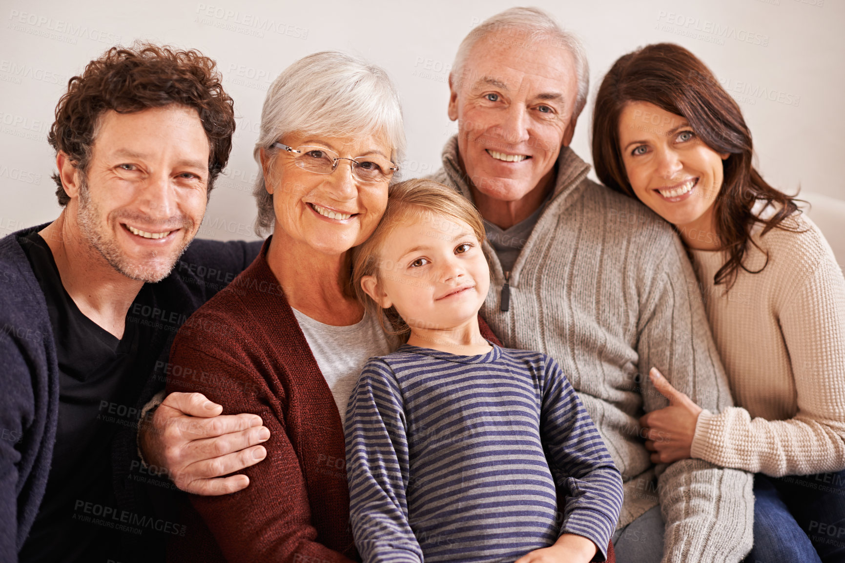 Buy stock photo Grandparents, parents and child on couch for portrait with hug, care or love with generations for bonding in home. Mother, father and senior people with kid for embrace on lounge sofa in family house