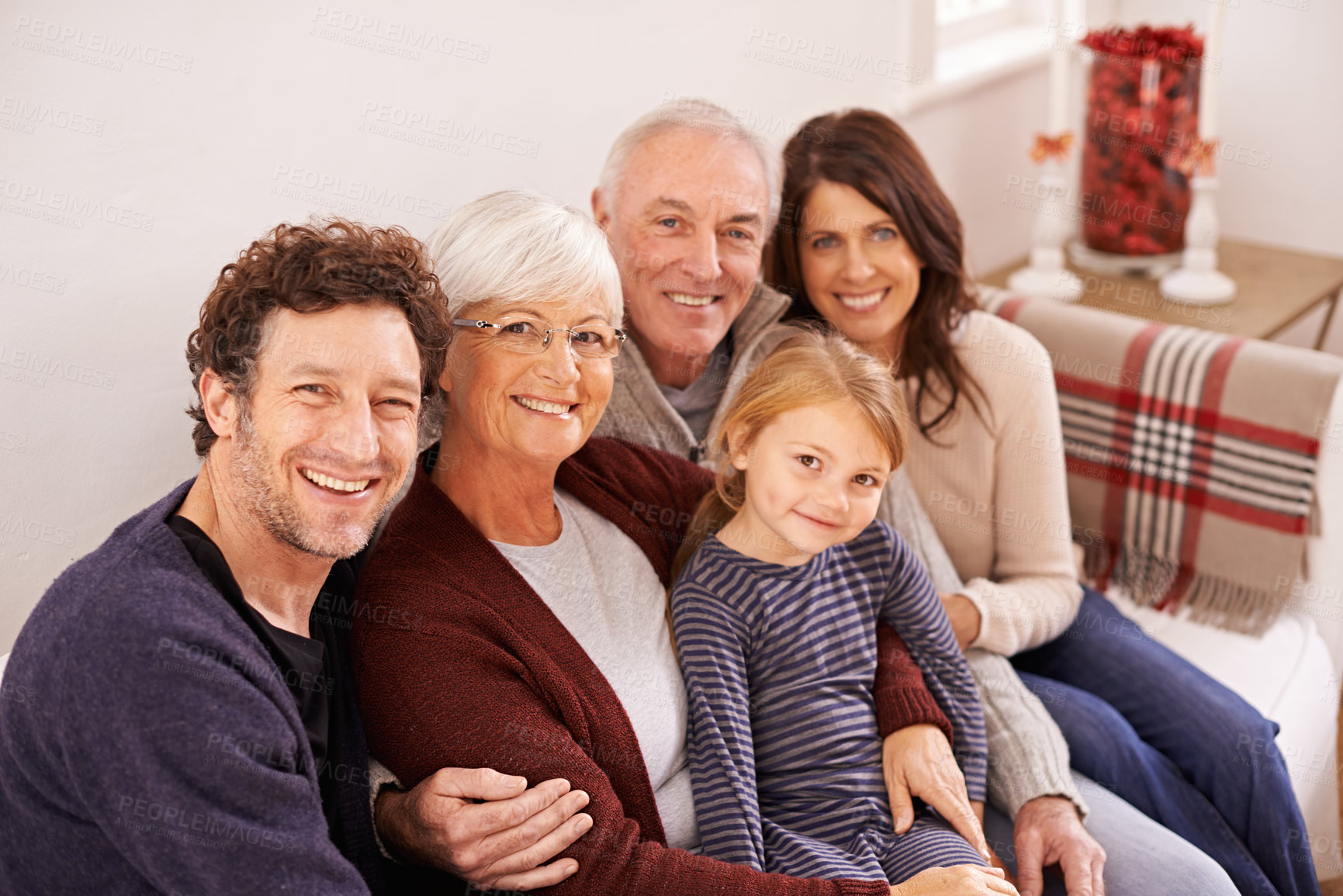 Buy stock photo Grandparents, parents and kid on sofa for portrait with hug, care or love with generations for bonding in home. Mother, father and senior people with child for embrace on lounge couch in family house