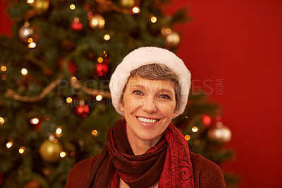 Buy stock photo Senior, woman and portrait on Christmas with smile for celebration, holiday and festive season with tree for decoration. Happiness, wellness and Santa hat for tradition, joy and positivity at home
