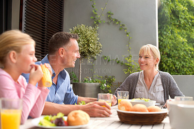 Buy stock photo Family, lunch and happy with child on patio with conversation, relax and eating in summer at house. Parents, kid and outdoor for brunch, food and smile for talking with bonding, connection and love