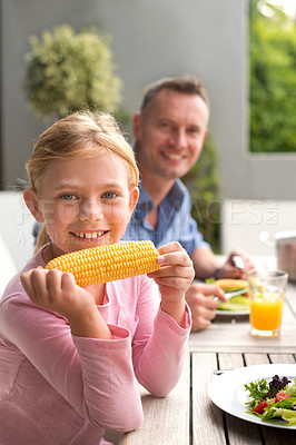 Buy stock photo A portrait of a happy young girl and her dad enjoying a meal outdoors