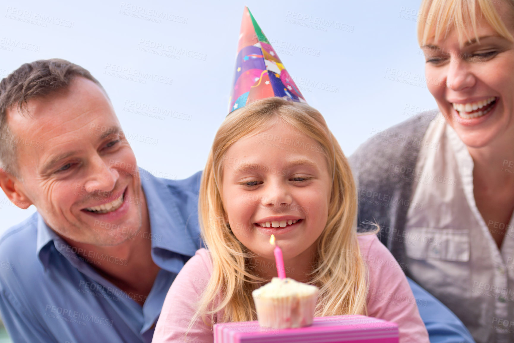Buy stock photo A cropped shot of a happy little girl and her parents celebrating her birthday