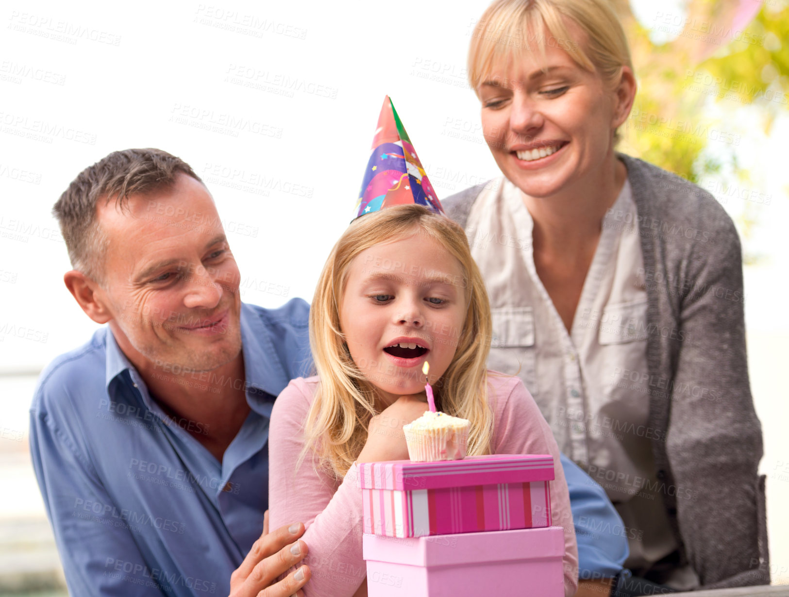 Buy stock photo Child, blow or candle for happy birthday, party or cake as fun wish, family or bonding together. Papa, mama or girl or smile at celebration, congratulations or childhood growth and development