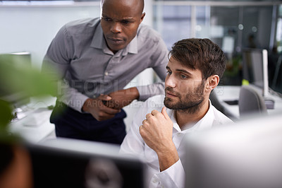 Buy stock photo Shot of two businessmen looking at a computer