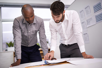 Buy stock photo Shot of two business colleagues going over some work