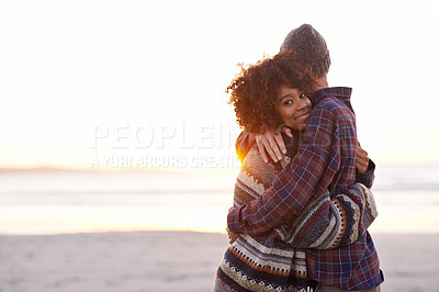 Buy stock photo Shot of a young couple enjoying a walk on the beach
