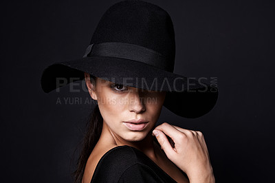 Buy stock photo Woman, portrait and fashion hat with mystery beauty on black background with makeup cosmetics, confidence or stylish. Female person, studio and model or mockup space in America, glamour or formal