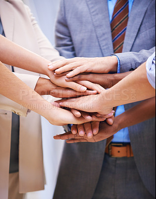 Buy stock photo Cropped shot of a group of coworkers with their hands in a huddle