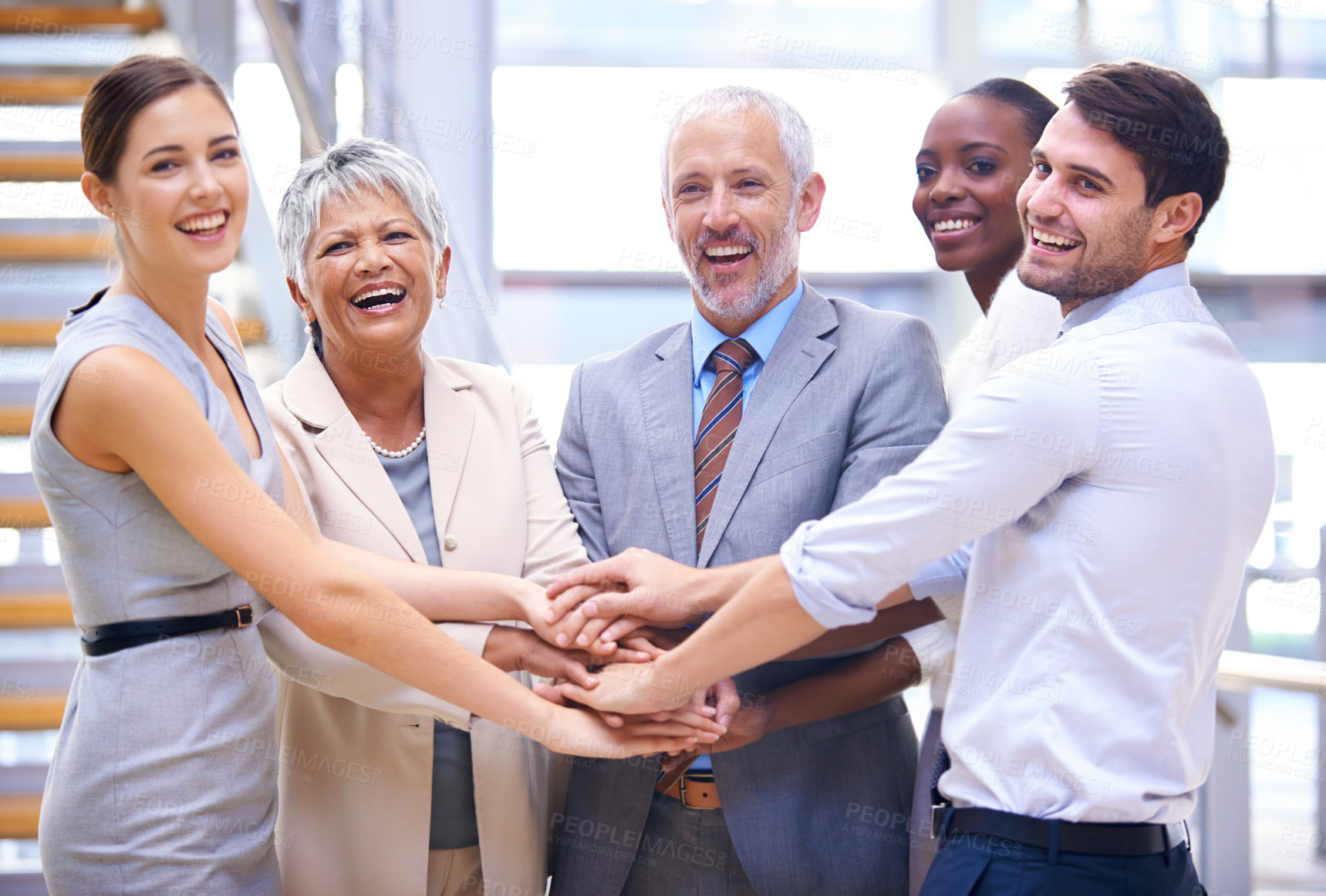 Buy stock photo Shot of a group of smilingcoworkers with their hands stacked