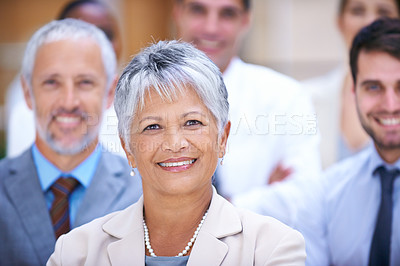 Buy stock photo Portrait of a smiling businesswoman surrounded by a group of her colleagues