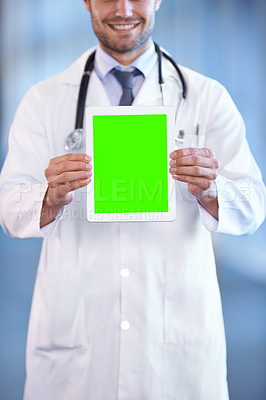 Buy stock photo Shot of a happy young doctor holding up a digital tablet so that the screen is facing the camera