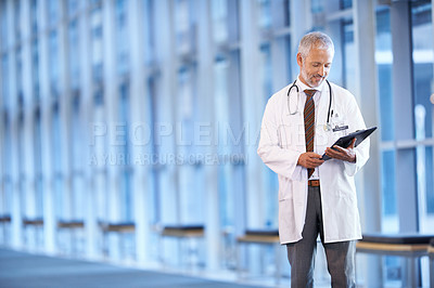 Buy stock photo Checklist, happy doctor and man reading in hospital for healthcare, wellness and notes. Clipboard, medical professional and smile of mature surgeon with paper, results and report on chart in clinic