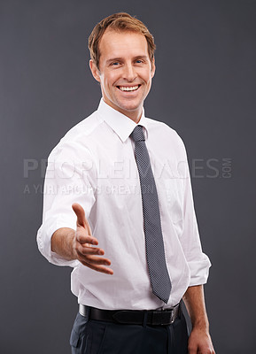 Buy stock photo Handshake, happy and portrait of a businessman in a studio for a partnership, greeting or deal. Corporate, smile and male model with a shaking hand gesture for agreement isolated by a gray background