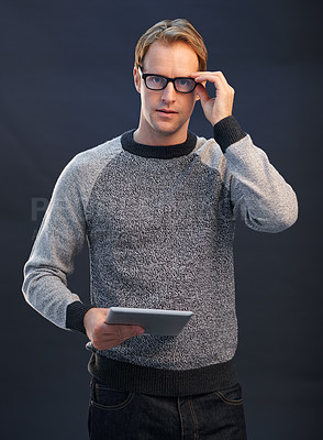 Buy stock photo Man, glasses and tablet in studio portrait with connection, contact and fashion by dark background. Person, nerd or geek with digital touchscreen, pride and confidence with app for social network