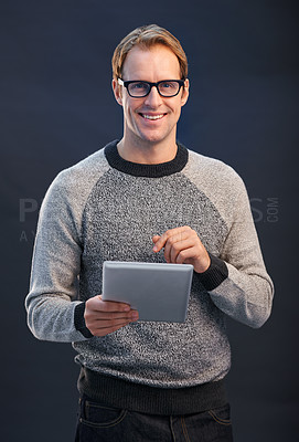 Buy stock photo Man, glasses and tablet in studio with smile for portrait, connection or contact by dark background. Person, entrepreneur or geek with digital touchscreen, pride or fashion with app for social media