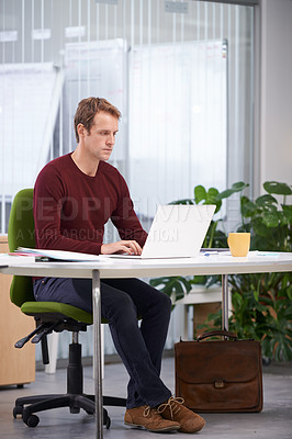Buy stock photo A handsome businessman working at his desk