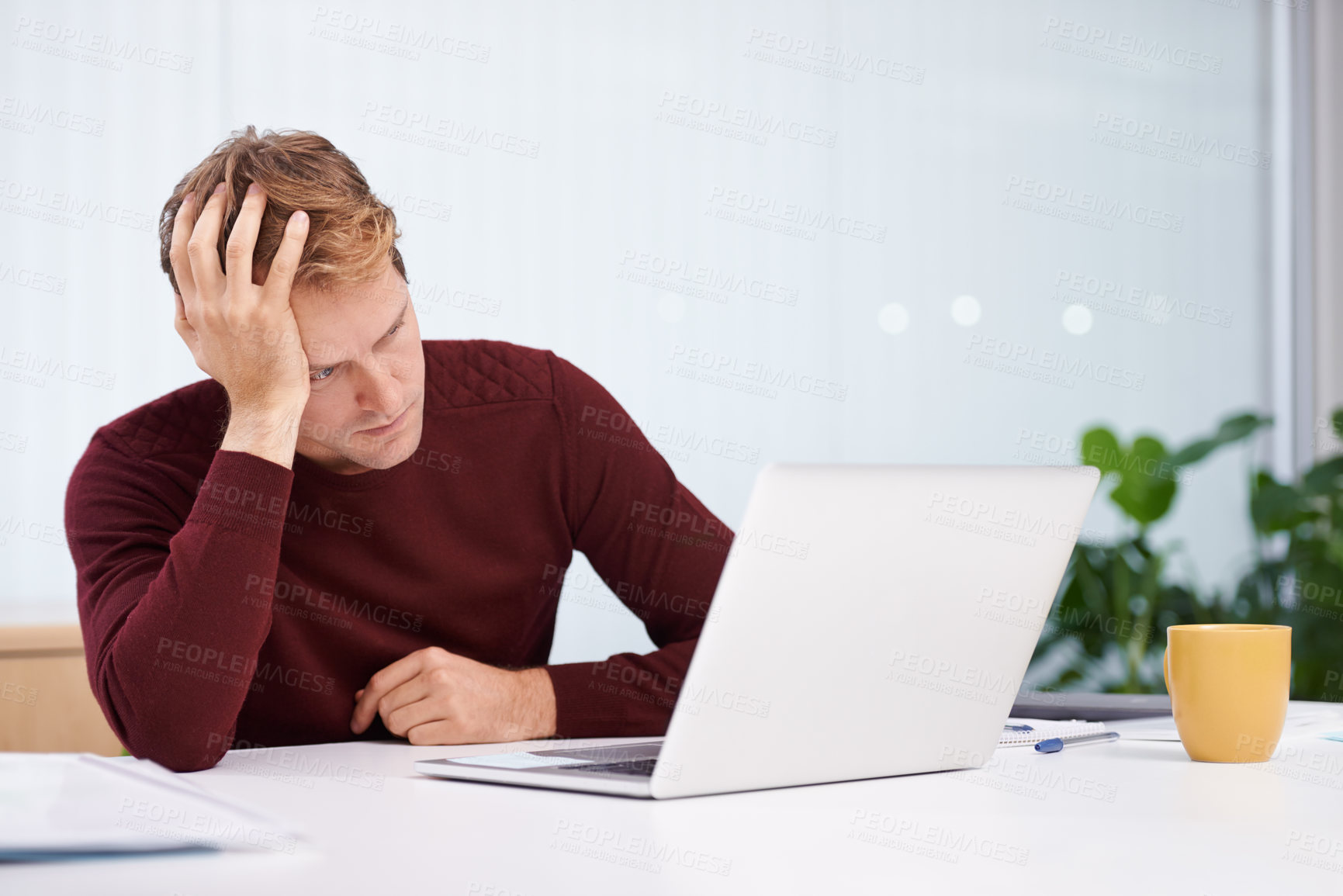 Buy stock photo A handsome businessman working at his desk