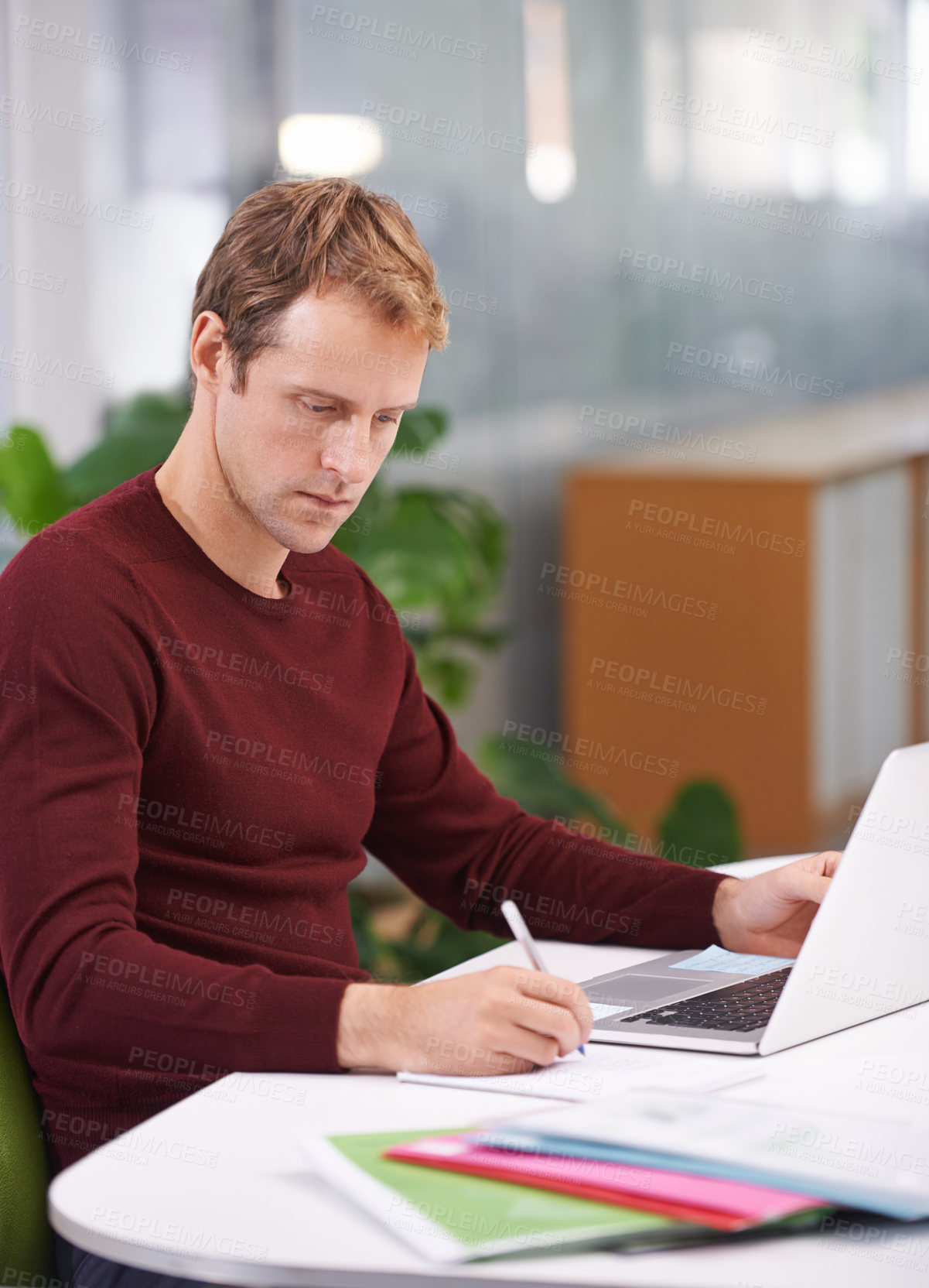 Buy stock photo A handsome businessman working at his desk