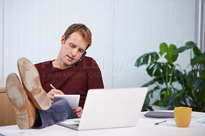 Buy stock photo A handsome businessman working at his desk