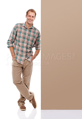 Buy stock photo Studio, billboard and portrait of man with mockup for promotion, information and fashion. Male person, smile and relax by banner for happiness, presentation and confidence on white background