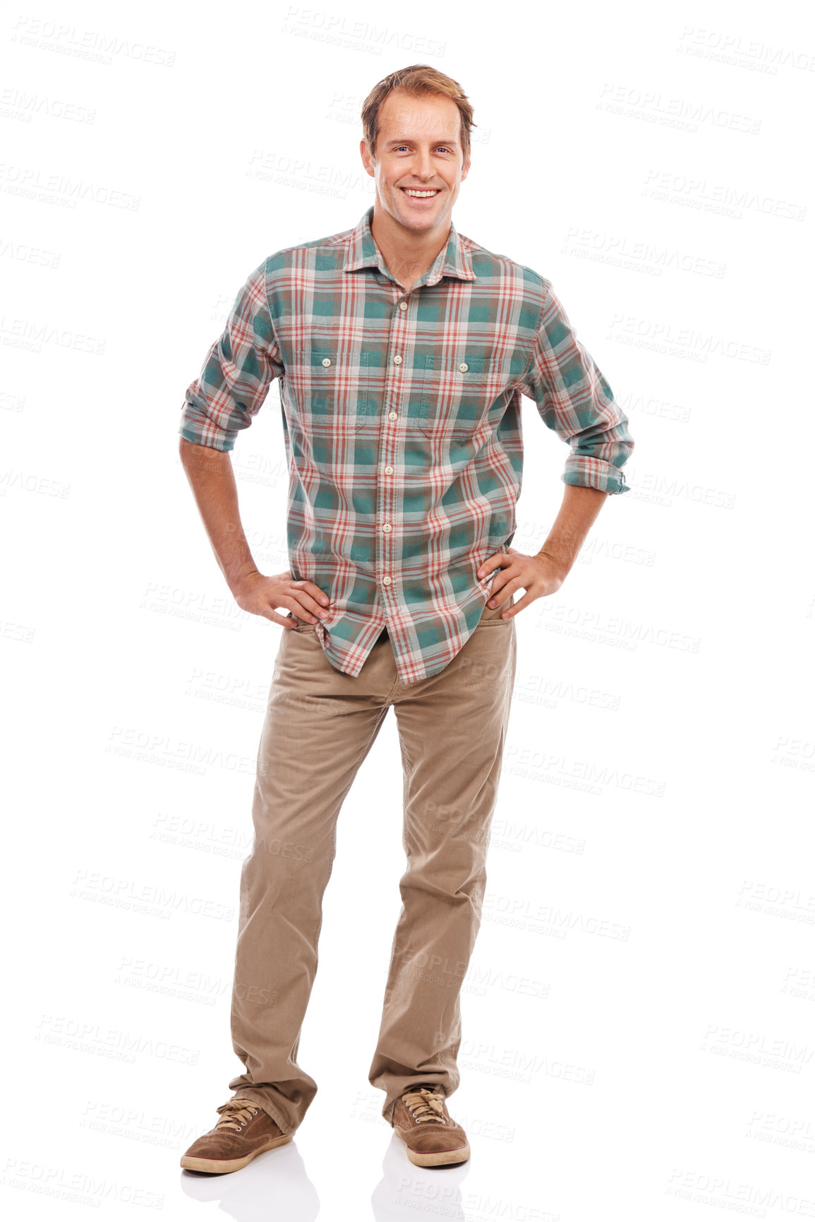 Buy stock photo Portrait of a handsome young man standing with his hands on his hips against a white background