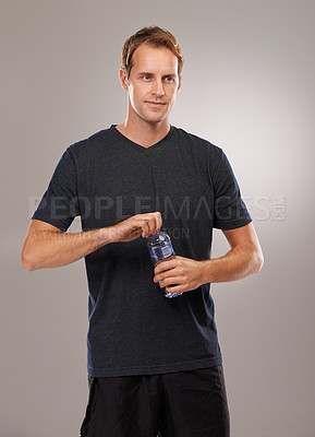 Buy stock photo Thinking, studio or man drinking water for fitness, hydration or workout break isolated on grey background. Healthy person, training or thirsty athlete with h2o liquid drink for exercise or detox