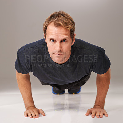 Buy stock photo Fitness, man and portrait in studio for push up, workout and exercise for wellness, health and diet. Young person and active for cardio, strength and gym for strong and fit on floor for sport   