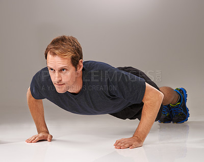 Buy stock photo Man, face and push up with fitness or workout in studio with exercise, serious and training with confidence. Athlete, person and physical activity on gym floor for healthy body on black background