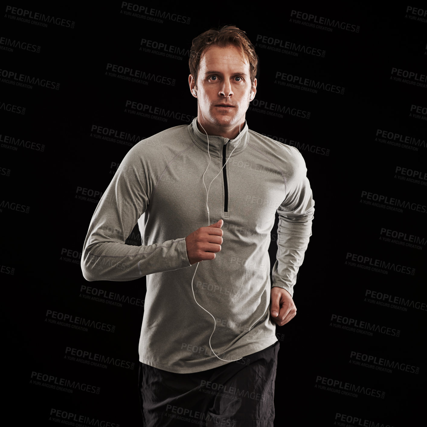 Buy stock photo Earphones, runner or man running in studio for training, cardio exercise or workout for health wellness. Male person, fitness or sports athlete on black background to jog with radio, music or podcast