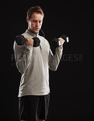 Buy stock photo Man, dumbbells and weightlifting training in studio or fitness performance, workout or black background. Male person, equipment and earphones for music playlist or healthy, streaming or mockup space