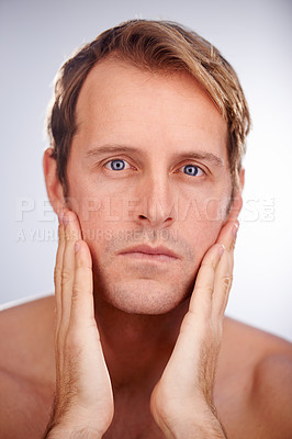 Buy stock photo Cropped shot of a man checking his stubble
