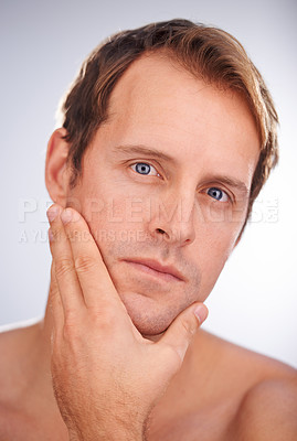 Buy stock photo Man, portrait and skincare dermatology in studio for healthy hygiene for cosmetic treatment, cleaning or white background. Male person, face and model or touching wellness, routine or mockup space