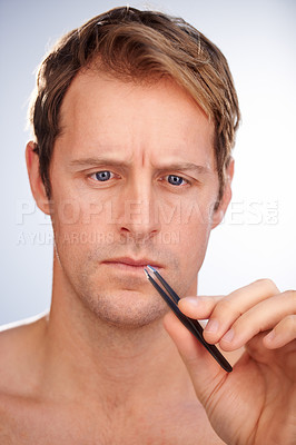 Buy stock photo Man, tweezers and eyebrow hair removal in studio for grooming, skincare or mockup space. Male person, tool and  plucking for dermatology microblading for transformation, cosmetic or white background