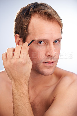 Buy stock photo Man, portrait and tweezers for eyebrow in studio or hair removal cleaning for grooming, skincare or mockup space. Male person, face and tool for wellness or plucking, dermatology on white background