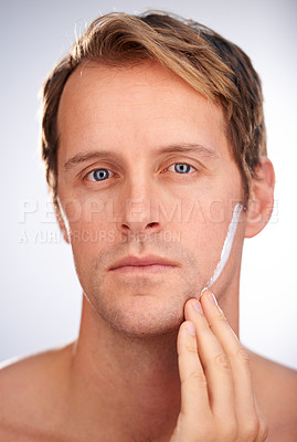 Buy stock photo Man, portrait and skincare cream in studio for moisturiser routine for dermatology, transformation or cleaning. Male person, face and product for hygiene lotion or facial, white background or mockup