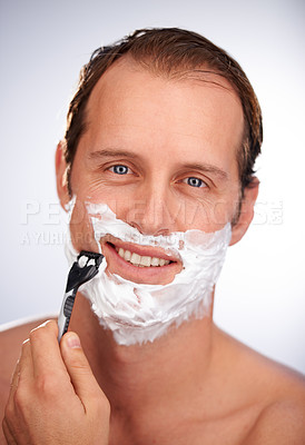 Buy stock photo Man, portrait and shaving cream with razor for beard hair removal or grooming, maintenance or white background. Male person, face and smile with tool for dermatology cleaning, studio or mockup space