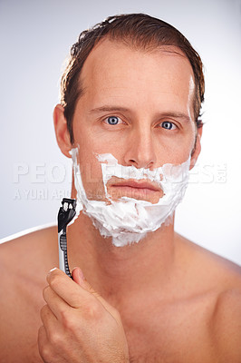 Buy stock photo Man, portrait and shaving cream with razor for beard hair removal or grooming, maintenance or white background. Male person, face and smile with tool for dermatology hygiene, studio or mockup space