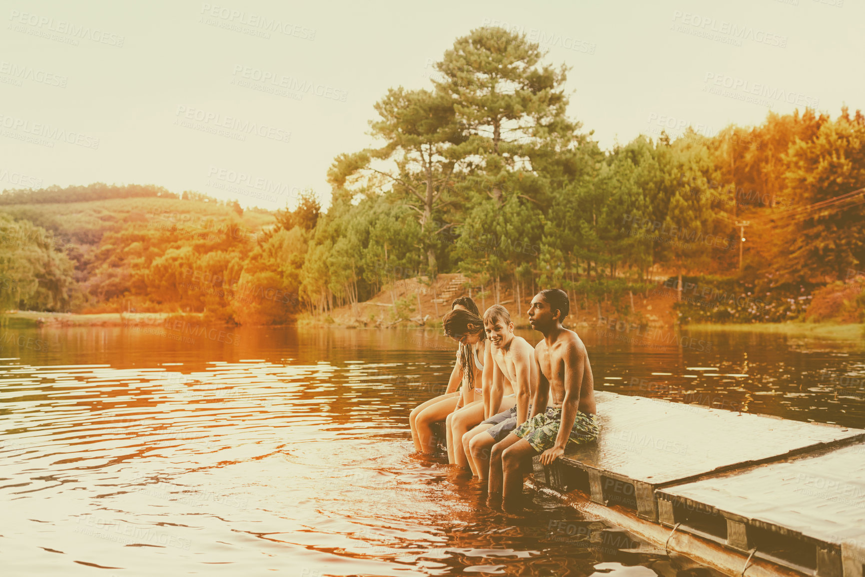 Buy stock photo Teenager, friends and lake pier as summer holiday or swimming vacation for connection, bonding or adventure. People, forest and river camping or weekend exploring or trip together, outdoor or journey