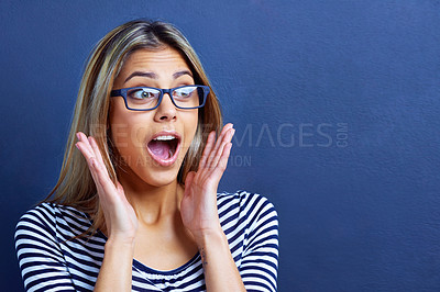 Buy stock photo Studio, scream and woman in shock with hands for promo or deal for clothes in fashion, sale and discount. Adult, female person and girl in blue background with glasses, aesthetic and announcement