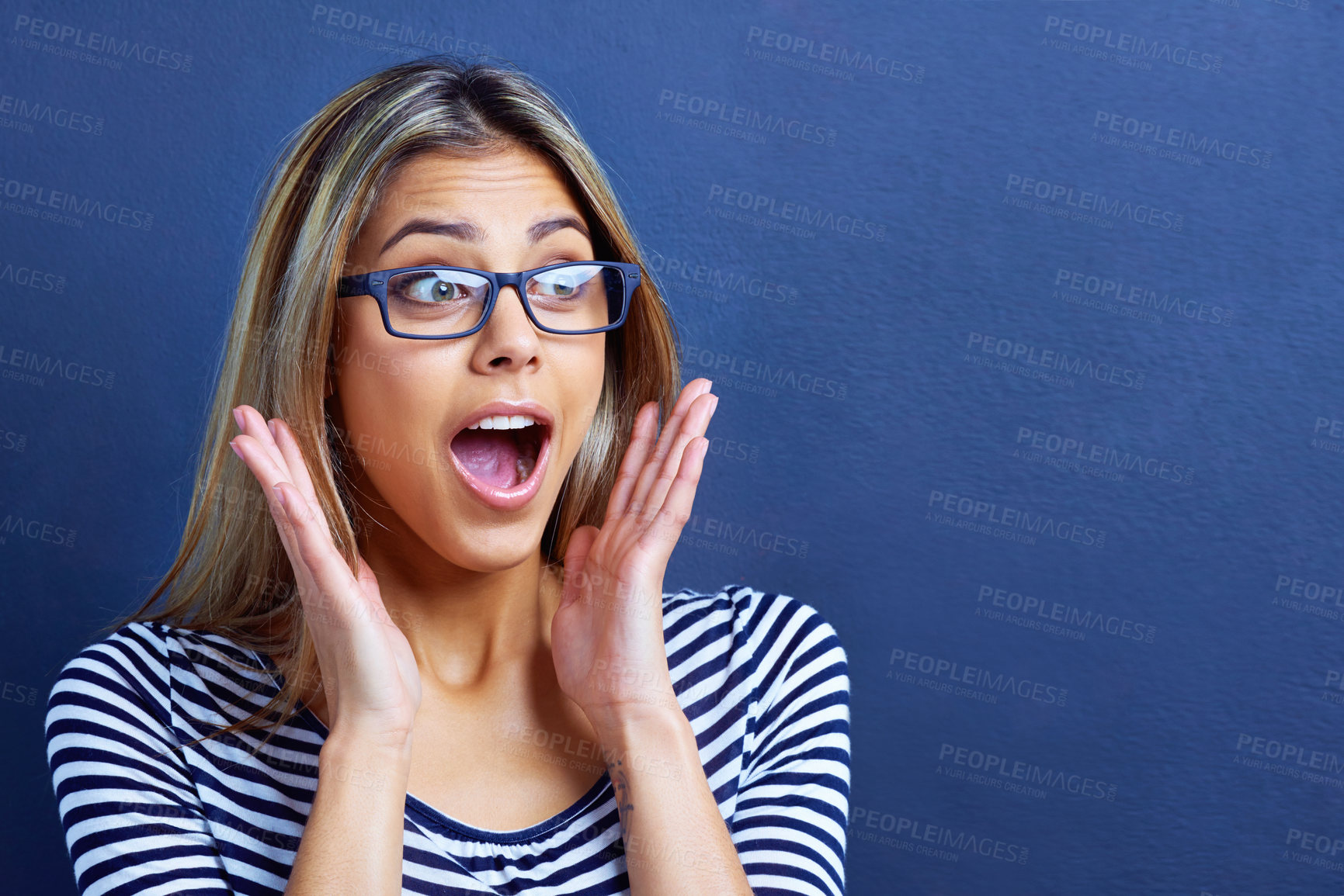 Buy stock photo Studio, scream and woman in shock with hands for promo or deal for clothes in fashion, sale and discount. Adult, female person and girl in blue background with glasses, aesthetic and announcement