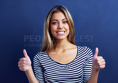 Buy stock photo Smile, portrait and woman with thumbs up, excited and happiness on face of female person. Blue background, hands and deal for fashion, aesthetic and cool with clothes, girl and joy in studio