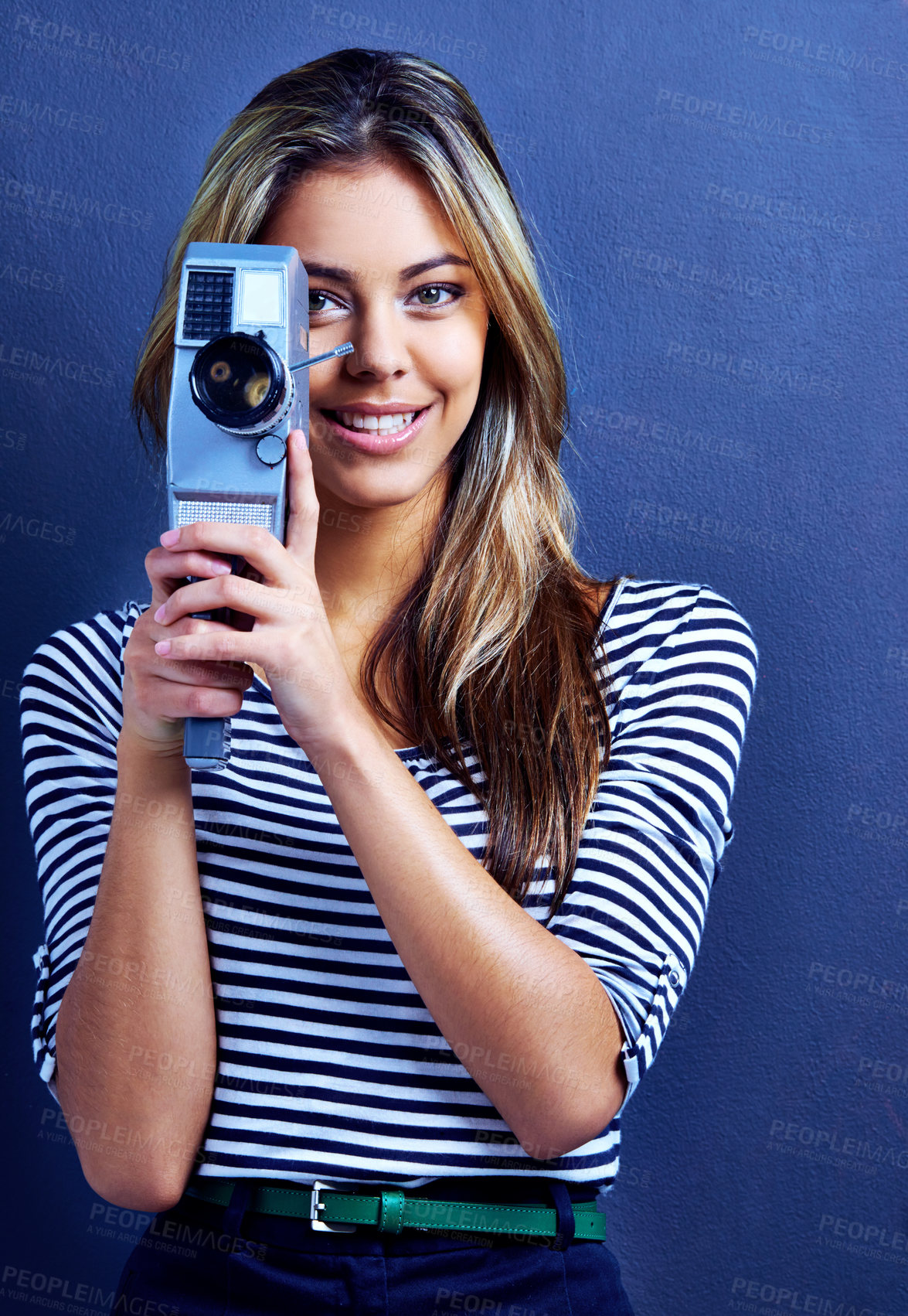 Buy stock photo Woman, happy and retro video camera in studio for recording, film and art in portrait by blue background. Girl, person or filmmaker with creativity, smile or shooting for independent movie production